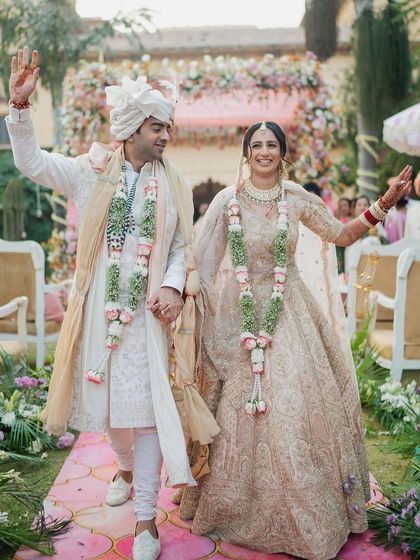 The couple's exit as husband and wife. The bride's hairstyle has held up perfectly through the ceremony.