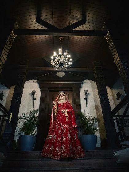 A dramatic and regal bridal portrait. The makeup is designed to be striking, with defined eyes and a sculpted look that photographs beautifully, even from a distance.