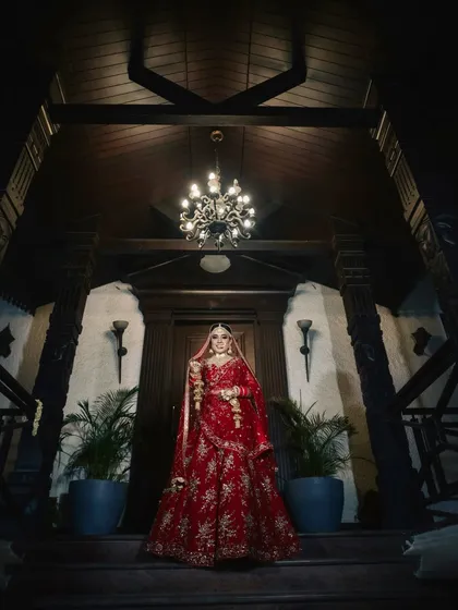 A dramatic and regal bridal portrait. The makeup is designed to be striking, with defined eyes and a sculpted look that photographs beautifully, even from a distance.