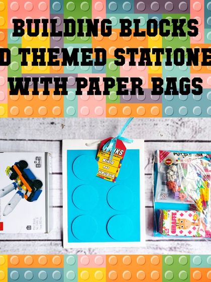 A complete building block and stationery set, shown with its matching blue paper bag and personalized thank you tag.