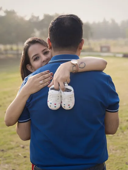 Sometimes the smallest things tell the biggest stories. A tiny pair of shoes, a loving embrace, and the promise of little feet that will soon be walking beside you. Outdoor sessions like this are perfect for capturing your story in a natural, candid way.