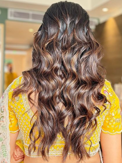 A pop of color for this Mehendi morning. We used a subtle color on the eyes, gave her glowing pink cheeks, and used a choker as a unique headband to complete her experimental and fun look.