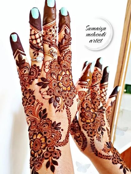 This party henna design is full of intricate floral details, covering the hands in a beautiful, dense pattern.
