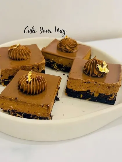 Another look at the Bournvita Milk Bars, showing the distinct layers of the biscuit base, the creamy mousse, and the glossy chocolate ganache on top.