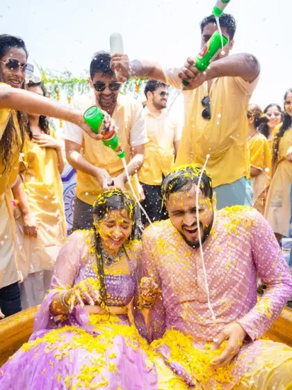 The couple gets drenched with water guns and turmeric during a fun-filled and messy Haldi celebration.