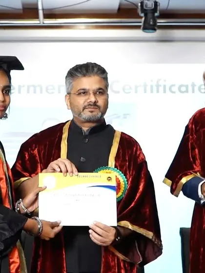 Presenting a graduation certificate to a student. It is a privilege to be part of this moment of achievement and celebration.