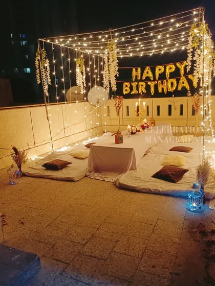 This wider shot shows how even a simple terrace can be turned into an intimate and special party space with the right lighting and seating.