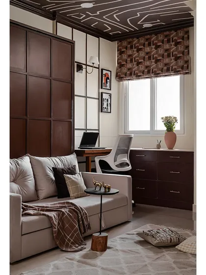 This versatile studio room features a Murphy bed that transforms into a sleek wall panel when closed. The beading details on the panel echo the design of the study nook, creating a cohesive look.