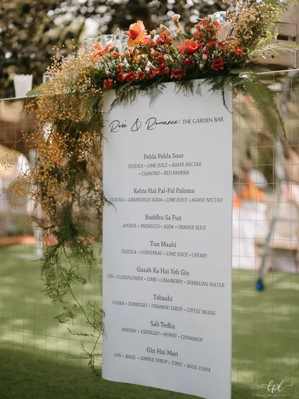 The "Desi & Romance" garden bar menu, featuring creatively named cocktails that added a playful touch to the event.