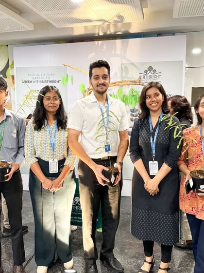 A group of young colleagues proudly holding their saplings. It's inspiring to see the next generation so engaged in protecting our environment.