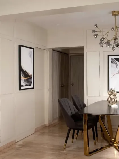 Another angle of the dining area, showing the relationship between the table, the hidden bar paneling, and the passage beyond. The consistent use of paneling creates a sense of rhythm and flow.