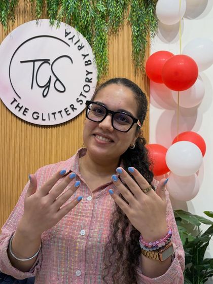 That smile says it all! She's showing off her new set of simple and chic baby blue nails.