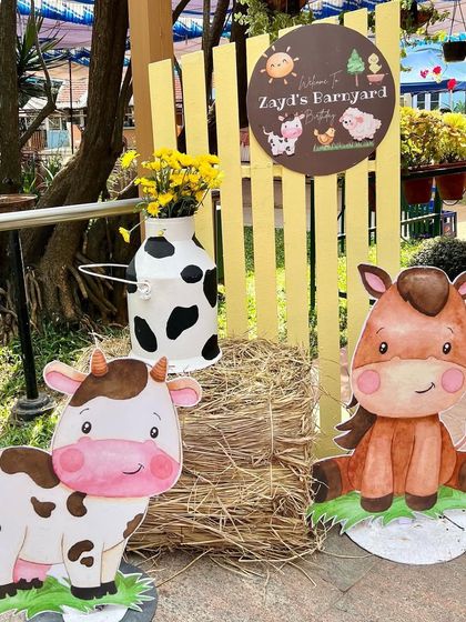 A charming welcome to Zayd's barnyard birthday. This entrance vignette features cute cow and horse cutouts, a bale of hay, and a personalized sign to greet the party guests.