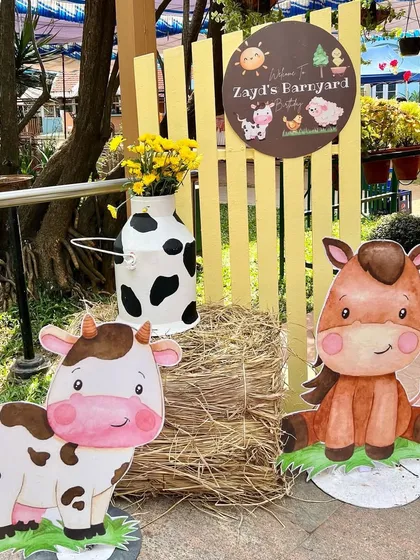 A charming welcome to Zayd's barnyard birthday. This entrance vignette features cute cow and horse cutouts, a bale of hay, and a personalized sign to greet the party guests.