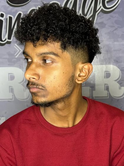 A stylish curly hair look. The fade on the sides makes the curls on top pop even more.