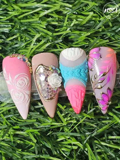 This set displays four distinct advanced techniques on stiletto nails. You can see embossed textures, a 3D floral design with glitter encapsulation, a textured sweater effect, and hand-painted art with gold foil accents.