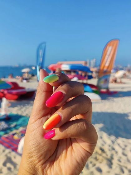 Another vacation shot of the vibrant ombré nails, this time at the beach. They are the perfect holiday accessory.