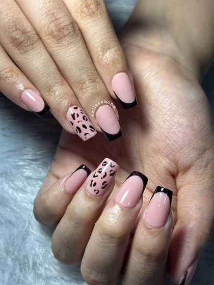 The square shape of these nails is perfect for showcasing the bold black tips and detailed leopard print.