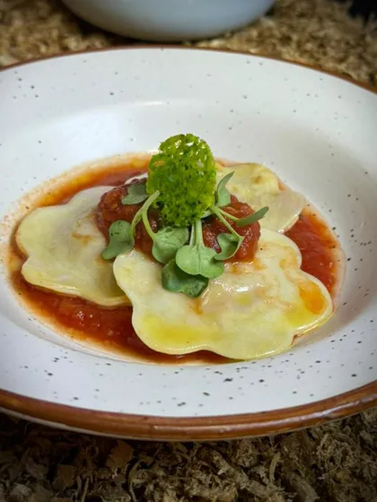 A beautifully plated ravioli dish served at The Gourmet Fest. This dish was part of our award winning presentation, showcasing our expertise in Italian cuisine.
