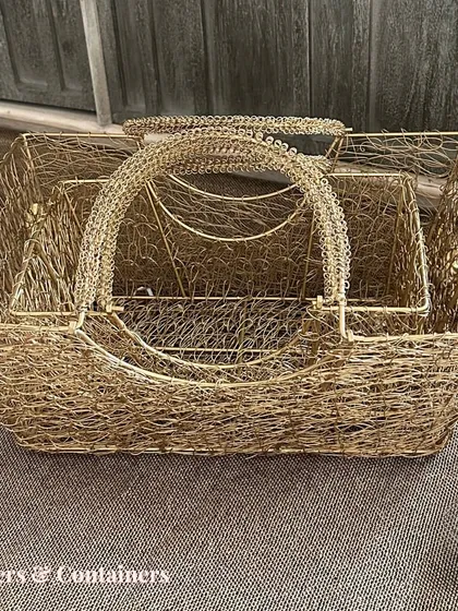 A set of nesting golden wire mesh baskets. These are incredibly versatile for creating hampers, storing items, or as decorative pieces on their own.