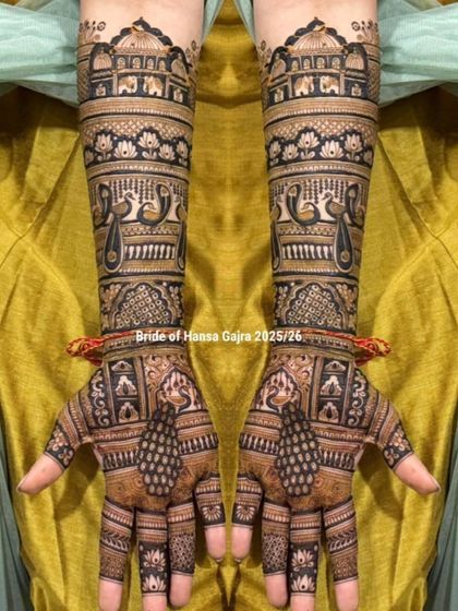 A beautiful example of a full-coverage traditional design. This mehendi features layers of royal architecture, peacocks, and lotus bands, creating a look of heritage on the hands.