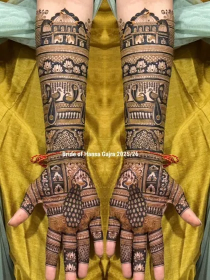 A beautiful example of a full-coverage traditional design. This mehendi features layers of royal architecture, peacocks, and lotus bands, creating a look of heritage on the hands.