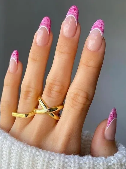 A beautiful and unique French manicure featuring pink marble-effect tips. This artistic design gives a soft and elegant twist to the classic look, perfect for any occasion.