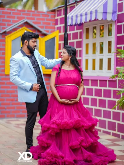 A stylish couple's portrait against a colorful, playful brick wall backdrop.