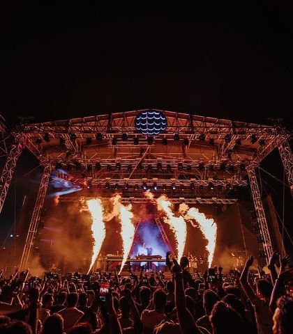Columns of fire erupt from the stage during Armin van Buuren's set, adding a raw, powerful element to the trance atmosphere.