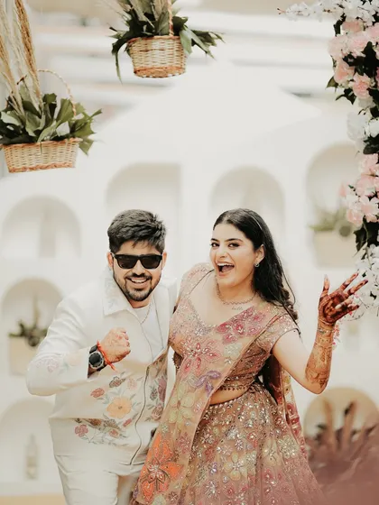 A fun and energetic shot of the couple. Their playful poses and big smiles perfectly capture the high spirits of their pre-wedding celebration.