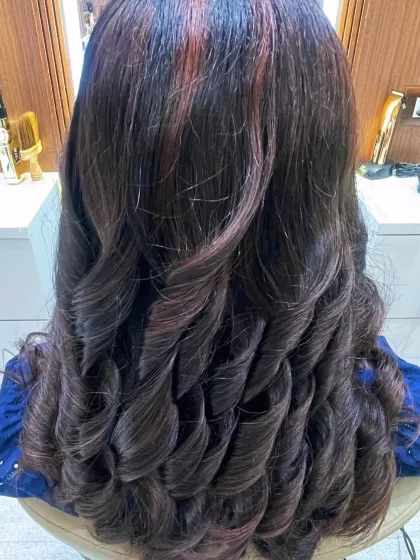 A full view of these perfectly defined curls. This is a great style for showing off healthy, well-maintained colored hair.
