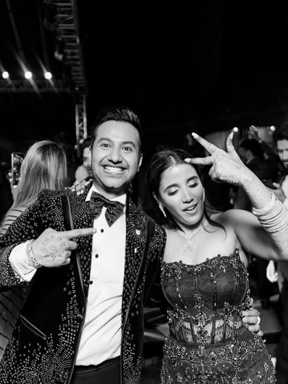 After the vows, it's time for the cocktail party. The bride looks stunning in a midnight blue embellished gown, ready to celebrate with her new husband.