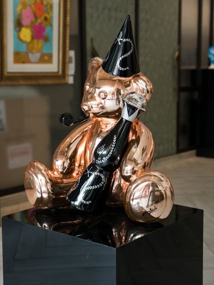 A different angle of the "Let’s Party Teddy," showcasing its playful yet luxurious presence in the gallery.