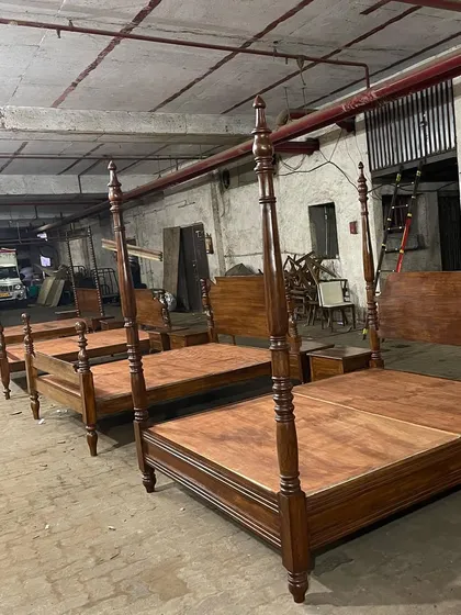 A lineup of colonial-style four-poster beds in my workshop, ready for the Panchgani project.