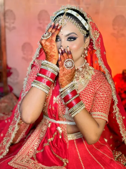 The quintessential shy bride pose. This highlights the intricate eye makeup and henna, showing how every element comes together for the final bridal look.
