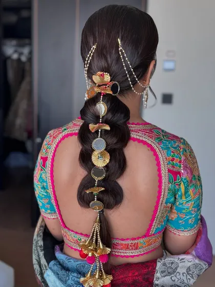 Another look at this intricate bridal braid. The combination of different accessories creates a rich, textured look that is truly a work of art.