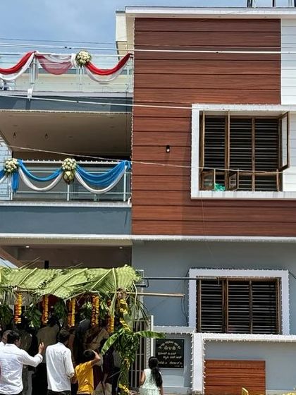 The completed house on inauguration day. This photo captures the proud moment when the architectural vision becomes a home.