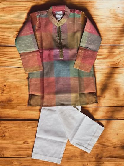 Embrace vibrant simplicity with this multicolored plaid kurta and classic white bottoms. The subtle golden detailing adds a touch of elegance to this playful outfit.