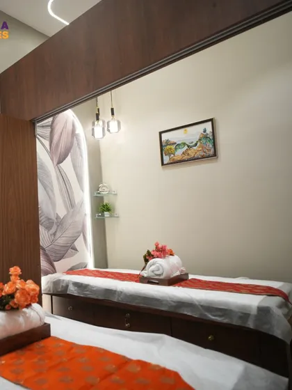 This view shows a pair of treatment beds, perfect for couples' packages. We used warm wood tones and soft, indirect lighting from the ceiling cove to create a shared space that still feels private and peaceful.