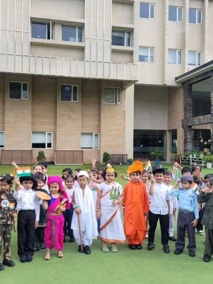 Students in costumes representing India's diverse freedom fighters raise their hands in a cheer. Our Independence Day celebrations are filled with patriotic fervor and a spirit of unity.