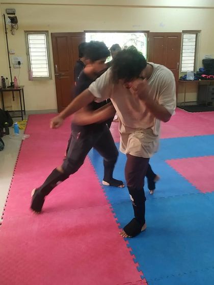 Two students engaged in a sparring exchange in the dojo. This is where they apply the techniques learned in class.
