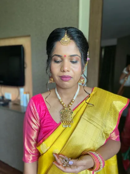 A beautiful client ready for a wedding. I gave her a classic South Indian look with a matte pink lip and a traditional updo.