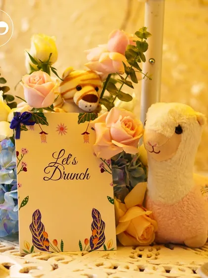 A playful centerpiece featuring stuffed animals alongside a floral arrangement, perfect for a fun and lighthearted celebration.