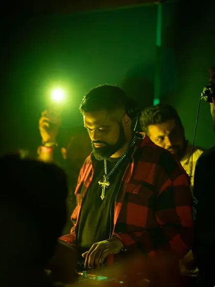 A focused shot of me at Waikiki, Mumbai. The green lighting and my plaid shirt give this a different, more relaxed vibe compared to the intense techno sets.