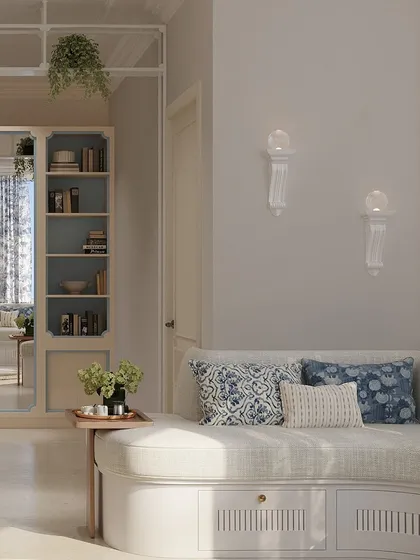 This serene tea room is designed with soft shades of blue and white for a calming, muted aesthetic. A curved, built-in sofa provides comfortable seating, perfect for unwinding.