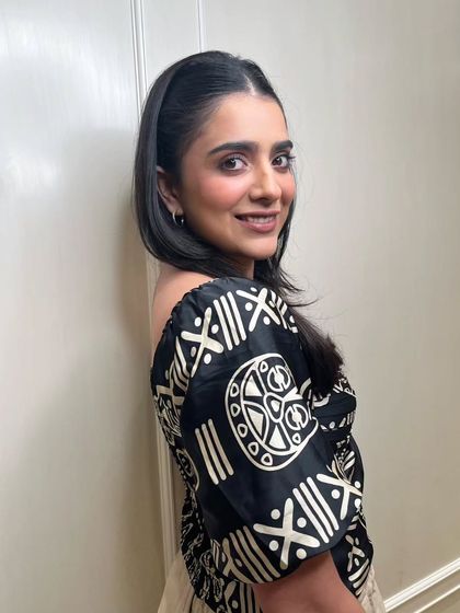 A side profile showcasing the soft contours and warm hues of a latte-inspired makeup look. The hair is styled back simply to keep the focus on the flawless, neutral makeup.