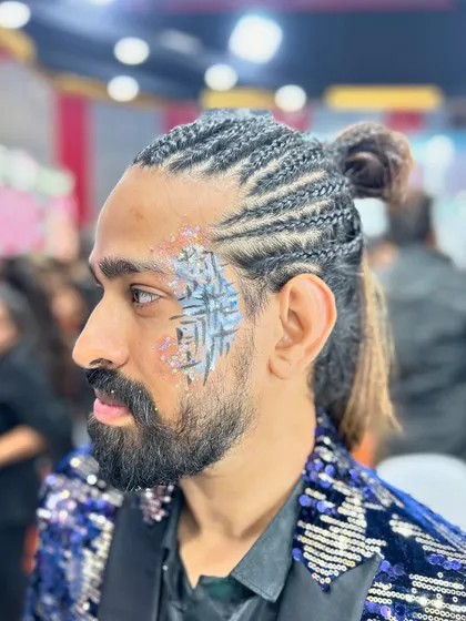 This client's braided hair and sequin jacket were the perfect match for this graphic, glittery face paint.