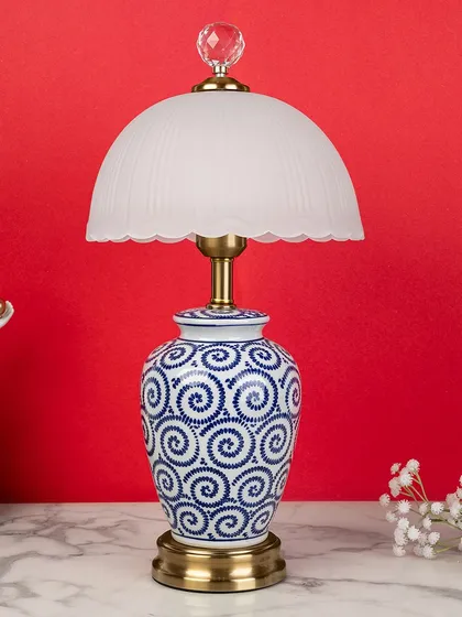 A playful spiral pattern gives this blue pottery lamp a more contemporary feel. Paired with the soft glow of the frosted glass dome shade, it's a unique piece that bridges classic and modern styles.