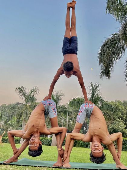 Teamwork makes the dream work. This three-person acro yoga formation showcases advanced balance, strength, and the fun we have in our group sessions.