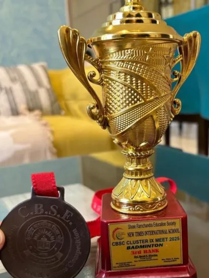 The trophy and bronze medal won by Vikrant Negi's school team at the CBSE Cluster Badminton Tournament.